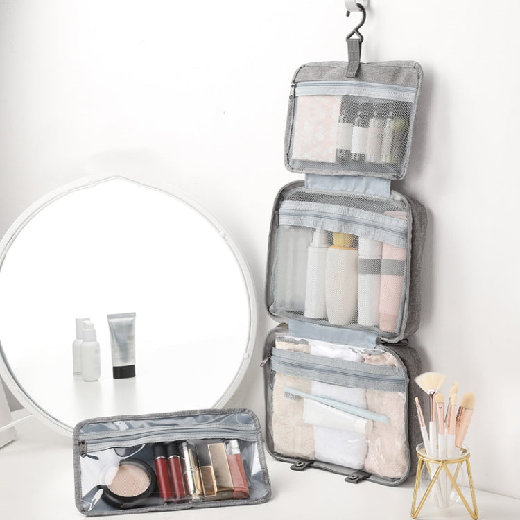 Gray foldable toiletry bag open with detachable inner pouch and clear zip compartments