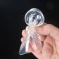 Clear silicone heel pad held in hand, contoured with raised tread