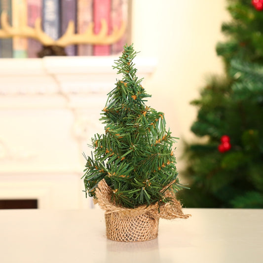 Mini Christmas tree desktop decoration with green needles and burlap-wrapped base