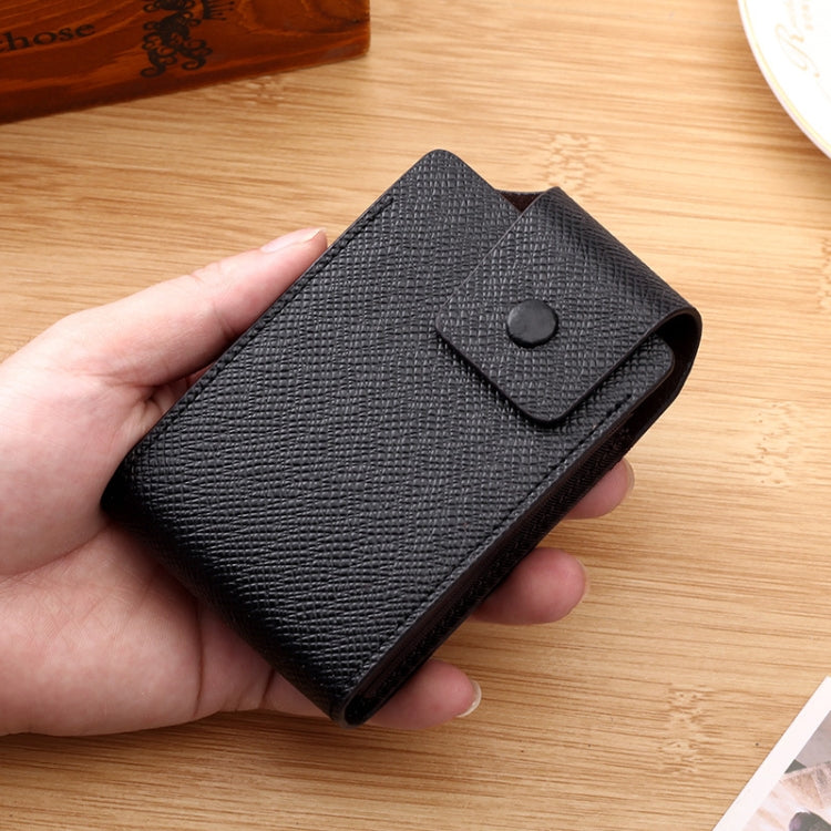 Textured dark blue card holder with snap-flap closure, held in hand