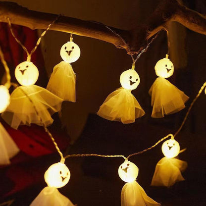 LED ghost string lights with warm white glowing faces and yellow tulle skirt ghosts