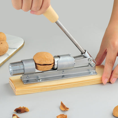 Walnut shell cracking plier with wooden handle and metal clamp on a base