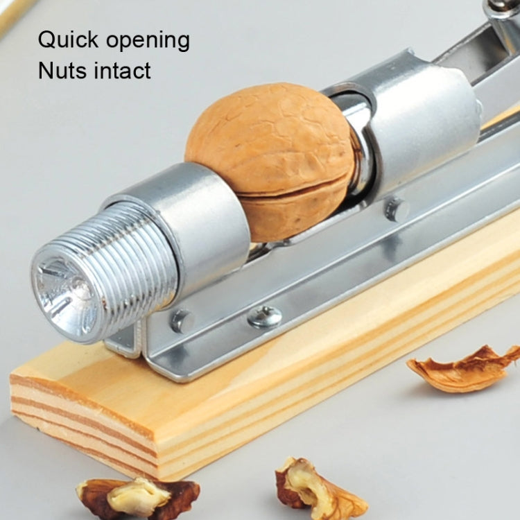 Walnut cracker plier holding a walnut shell between metal grips