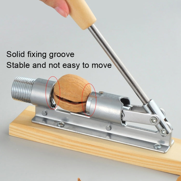 Walnut shell cracker plier with fixed groove holding a walnut on metal base