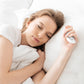 White microcurrent sleep aid massage device held by a person resting