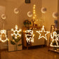 Set of glowing hanging LED Christmas figures with suction mounts on walls