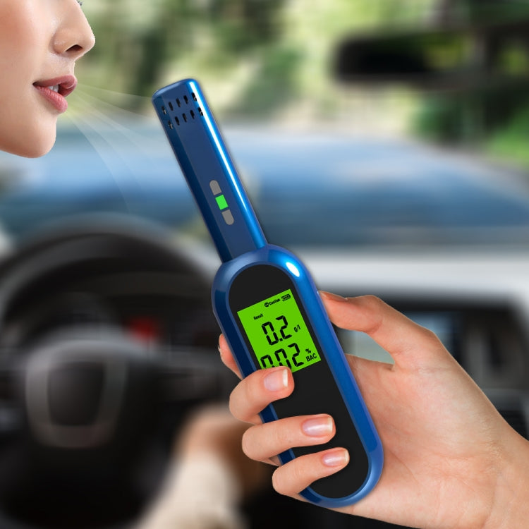 Blue breath alcohol tester with glowing green digital reading in hand
