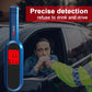 Blue breath alcohol tester held near a car window with digital display lit