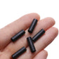 Black plastic brake/shift cable caps in hand, small cylindrical end caps