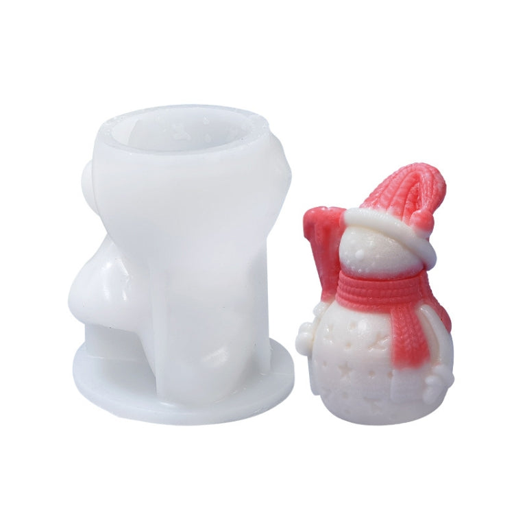 White silicone candle mold set with snowman-style mini candle on the right.
