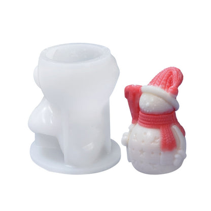 White silicone candle mold set with snowman-style mini candle on the right.