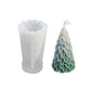 White silicone candle mold with green Christmas tree candle; icicle-like texture visible.