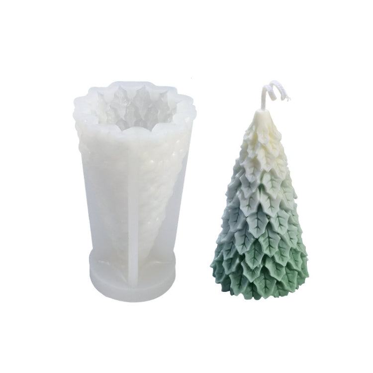 White silicone candle mold with green Christmas tree candle; icicle-like texture visible.