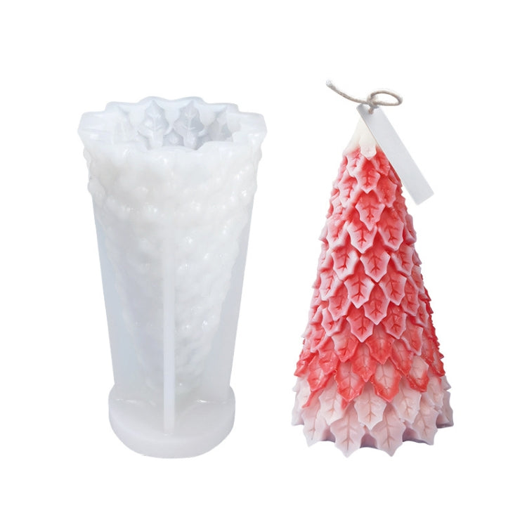 White silicone candle mold with pink Christmas tree candle; layered star patterns visible.