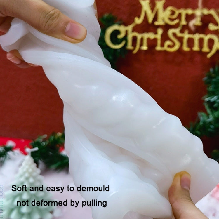 Hands demolding a white Christmas candle from a flexible silicone candle mold