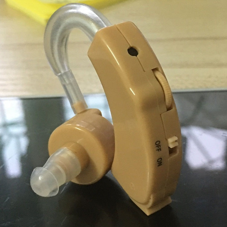 Tan hearing aid device with clear earhook tube and side control label