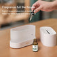 White desktop flame aromatherapy humidifier with essential oil bottle and dropper nearby.