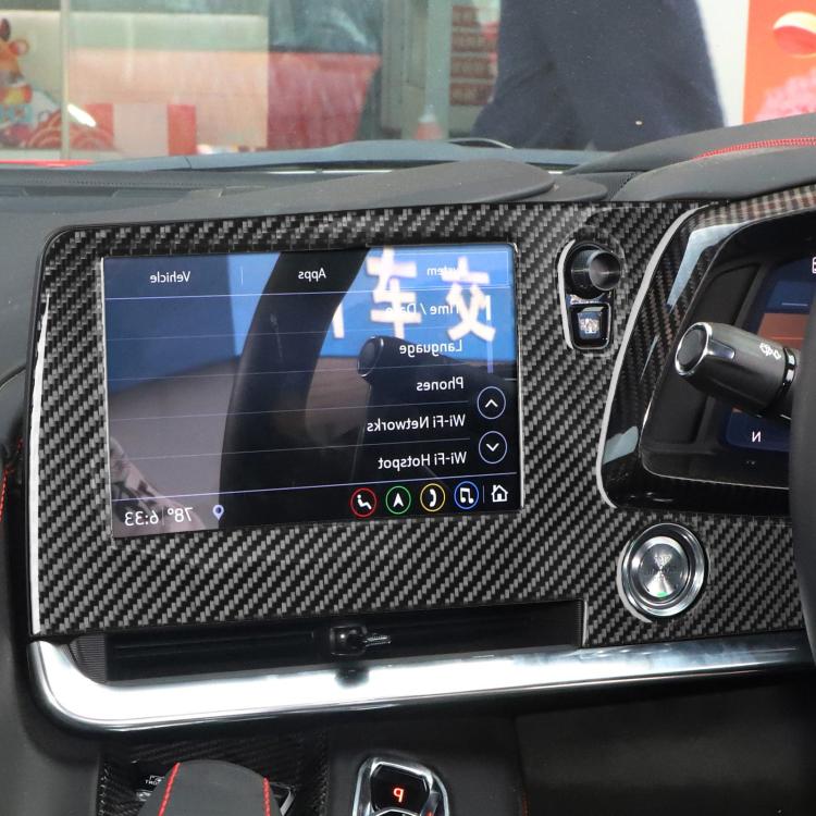Carbon-fiber screen frame sticker surrounding central touchscreen on right-hand drive