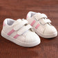 Children's white sneakers with pink side stripes and double hook-and-loop straps