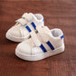 Children's white sneakers with blue side stripes and two-strap Velcro closures