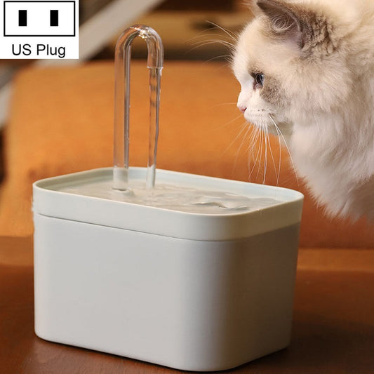 White automatic cat drinking fountain with clear spout and cat drinking from basin
