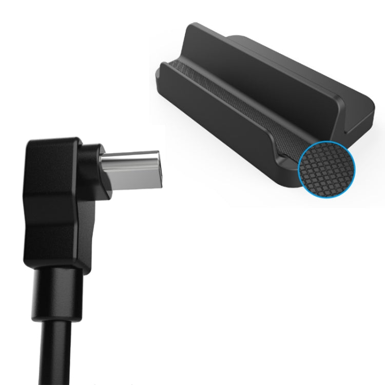 Black console stand with textured grip base and charging plug
