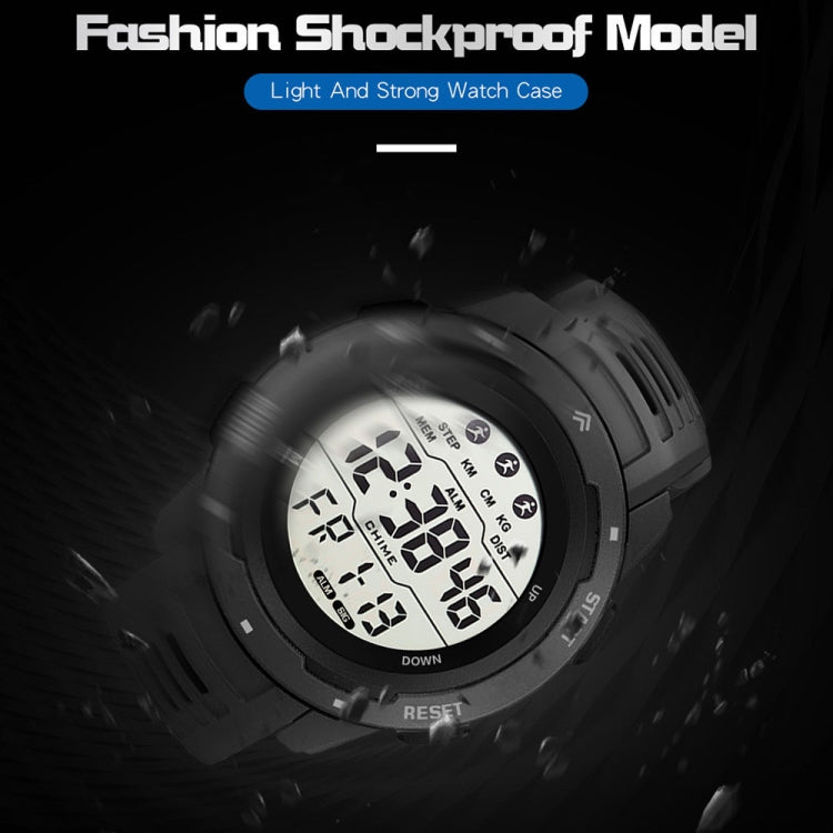 Grey digital running watch close-up with large LCD display and rubber strap