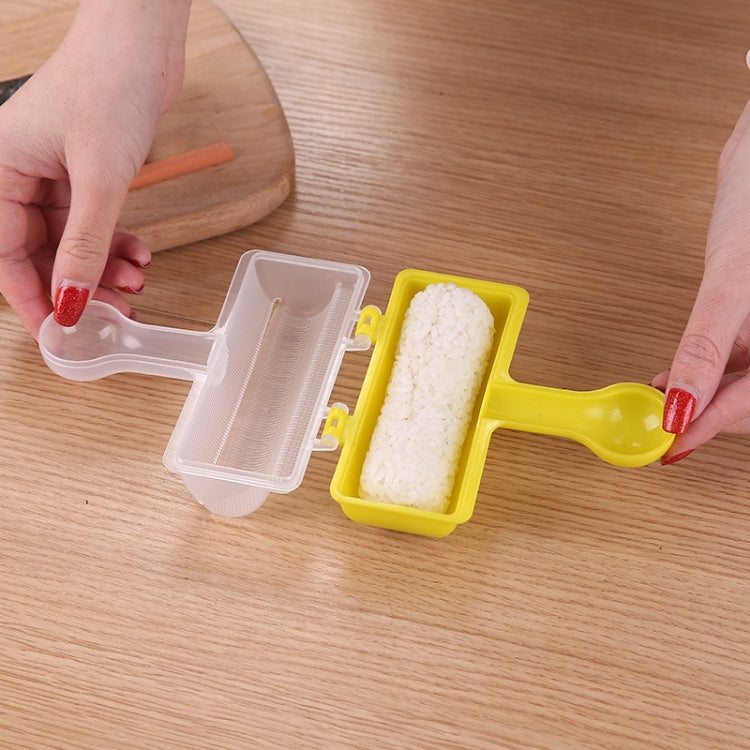 Handheld sushi roll mold with open clear tray and yellow container holding rice