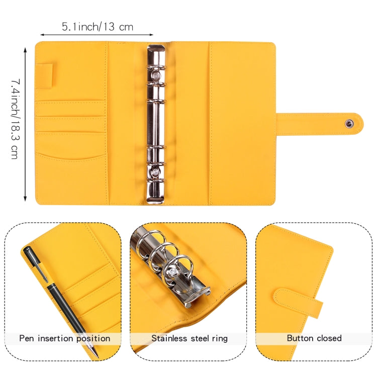Yellow loose-leaf notebook showing stainless-steel rings, pen slot, and button-strap closure
