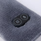 Close-up of dark gray heated neck scarf control panel with button icons
