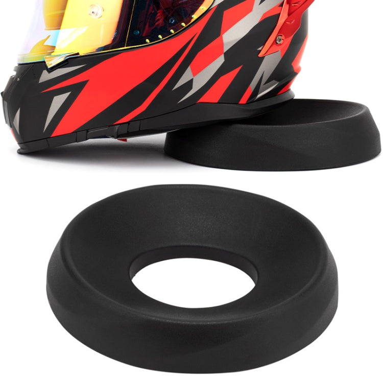 Black circular motorcycle helmet support pad with center hole, anti-slip base