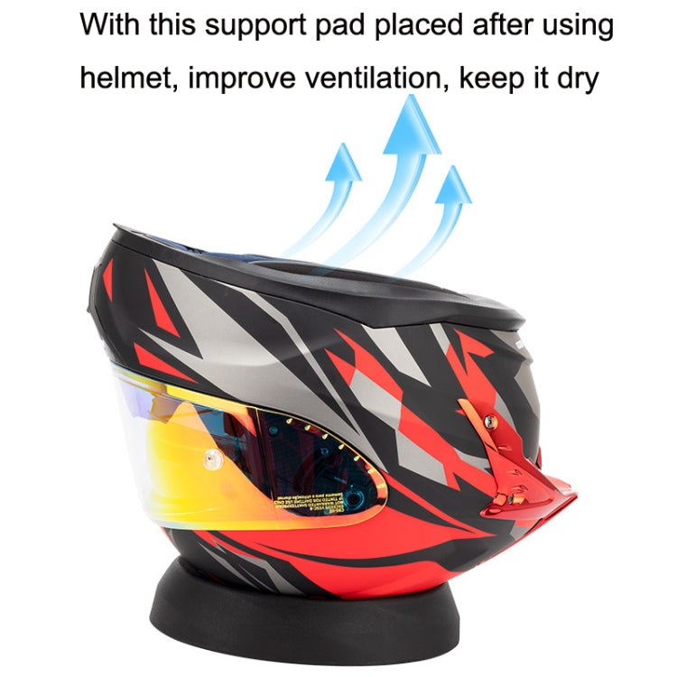 Black helmet support pad placed under motorcycle helmet for ventilation airflow