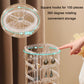 Clear 360° rotating earring organizer rack with square hook rows and a hand adding earrings