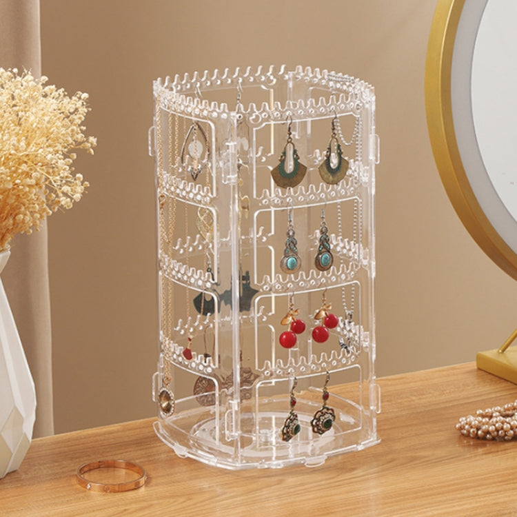 Clear rotating earring storage rack with layered hooks, displaying assorted dangling earrings