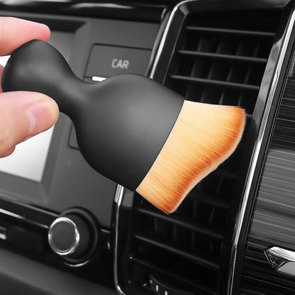 Car air vent cleaning brush with black handle and orange bristle head