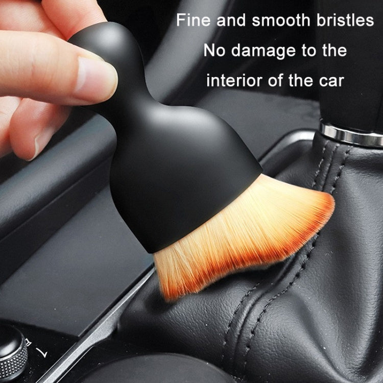 Car interior cleaning brush with black handle and orange soft brush head