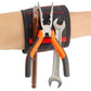 Magnetic wrist strap with red stitching holding tools; black strap with metal pliers