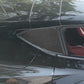 Carbon-fiber-look triangular rear window sticker installed on car trim, dark gray