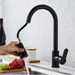 Black pull-out kitchen faucet with handheld sprayer over countertop