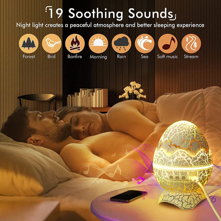 LED dinosaur egg night light glowing on bedside on a pillow