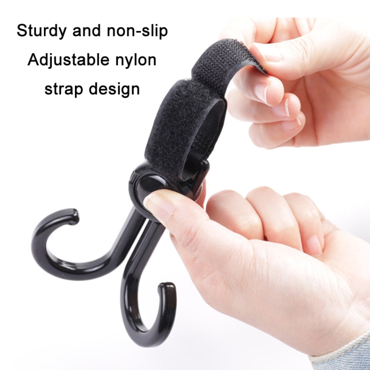 Hands adjusting a gray non-slip strap on a curved stroller hook