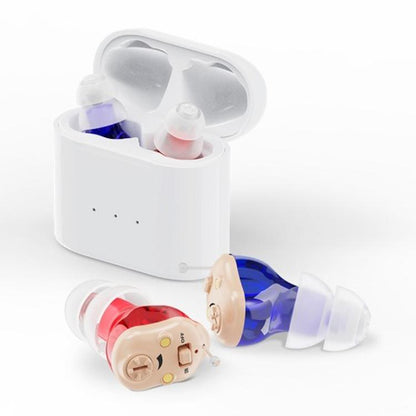 White charging case open with two CIC hearing aids, red and blue silicone tips