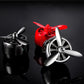 Car air outlet perfume swivel fans, one black and one red with three blades each