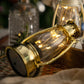 Gold retro lantern close-up with clear glass globe and metal loop handle