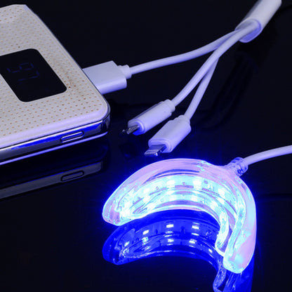 LED teeth whitening device with glowing mouth tray and connected charging cables