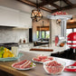 Stand mixer meat grinder attachment in use with ingredient bowls on the countertop
