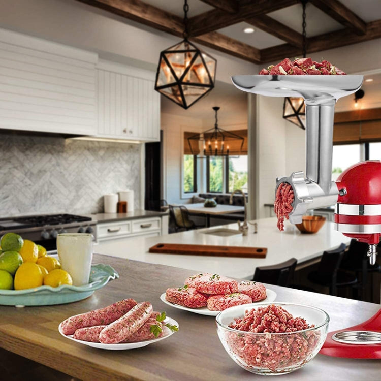 Stand mixer meat grinder attachment in use with ingredient bowls on the countertop