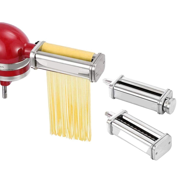 Noodle pressing attachment with yellow pasta strands and stainless steel rollers