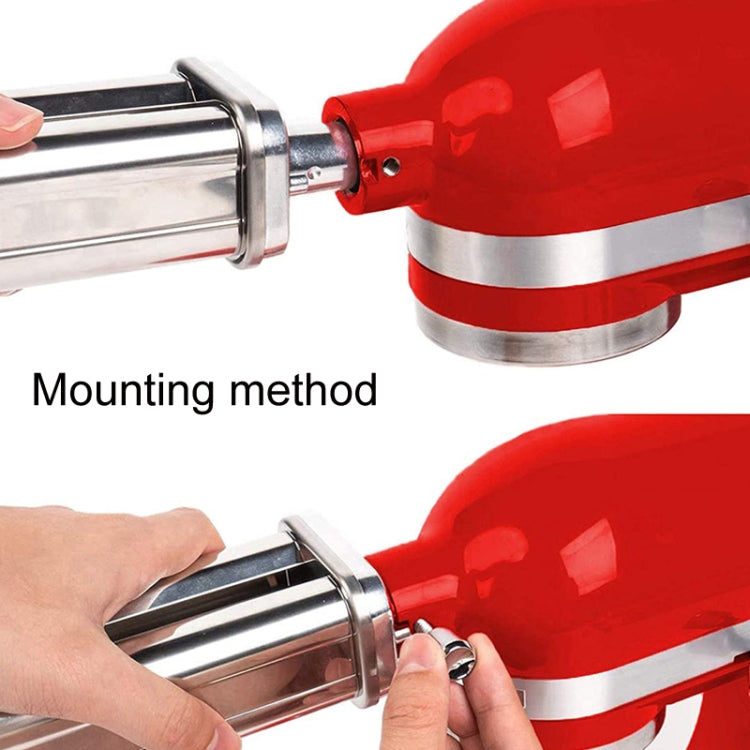 Noodle press attachment mounted on red motor housing with stainless steel rollers