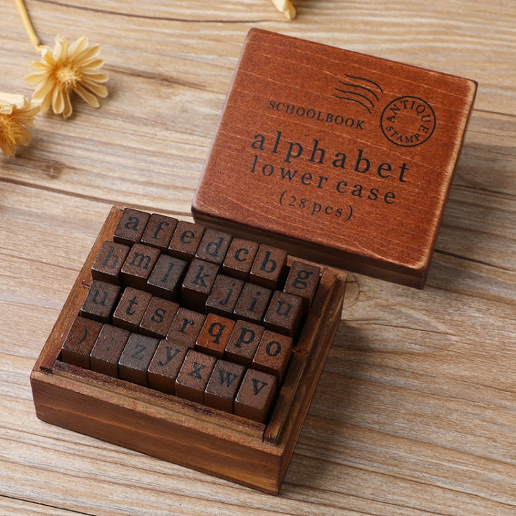 Wooden alphabet stamp set in box, lowercase letters with dark metal stamp faces